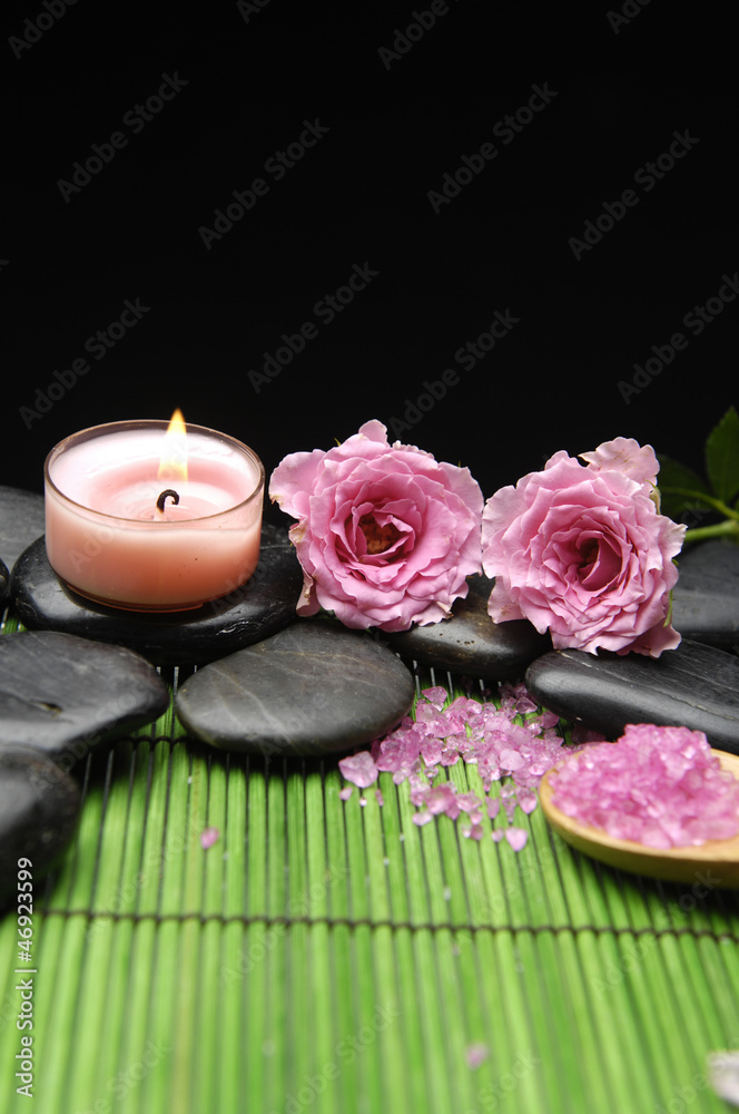 Pink rose and zen stones with herbal salt in spoon with candle Pink rose and zen stones with herbal salt in spoon with candle