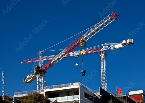 High rise cranes on city office construction site