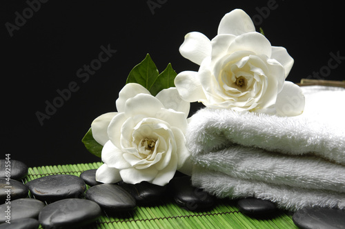 White Gardenia and stones with towel on green mat