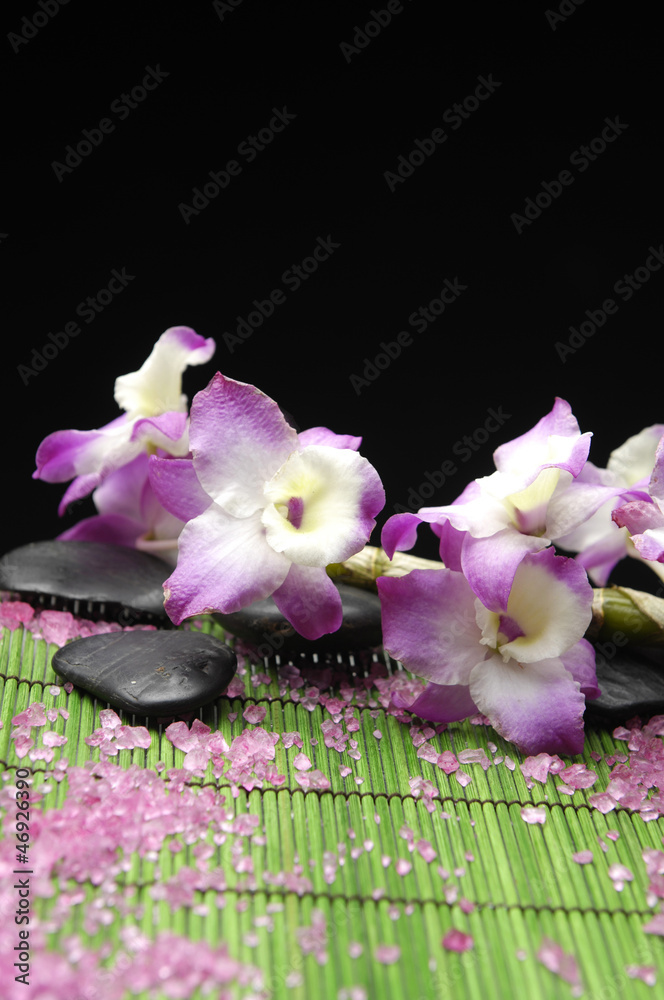 pink branch orchid with zen stone and pile of salt on mat pink branch orchid with zen stone and pile of salt on mat