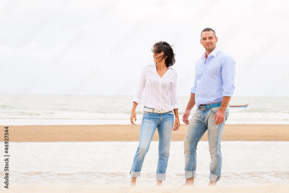 Smiling young couple at beautiful summer beach