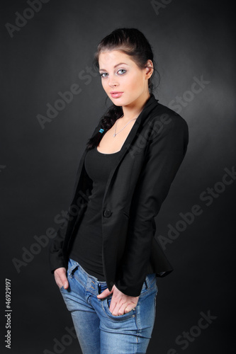 Beautiful brunette girl in coat pose, hold hands in pockets