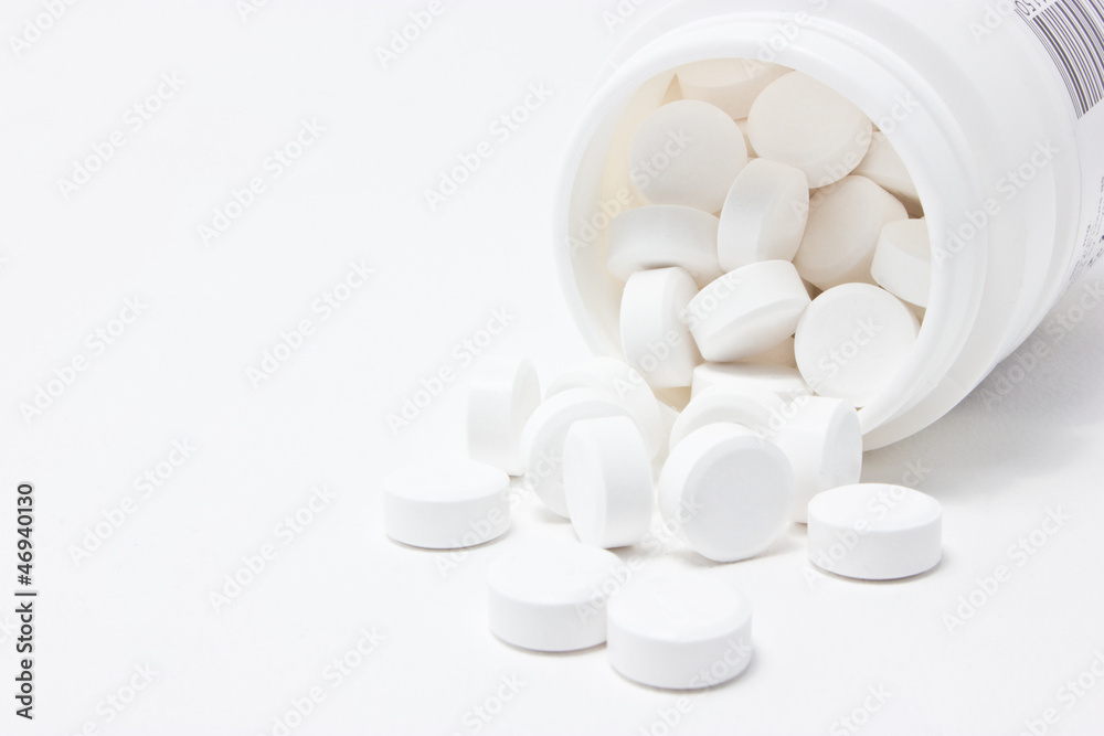 White medicines flow from container. White medicines flow from container.