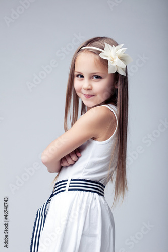 Pretty blonde little girl in white dress photo