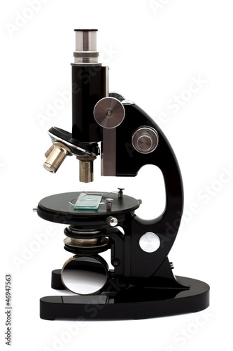 Old microscope isolated on white background