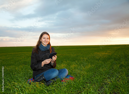 Teen girl reading electronic book outdoors © andreykr