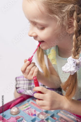 portrait of a little caucasian fashionable girl using decorative