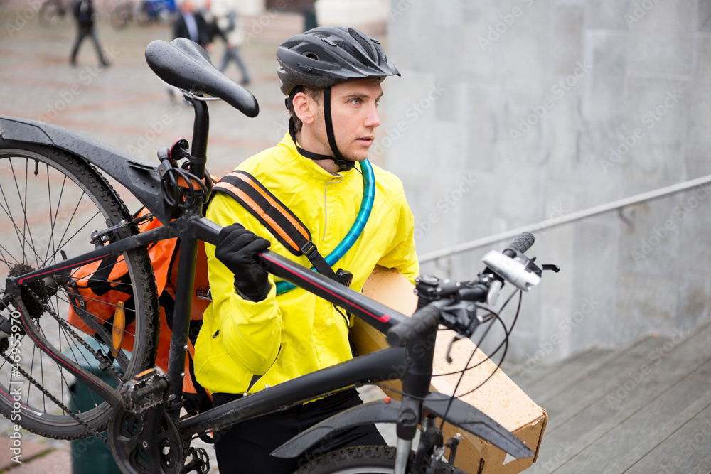 Courier Delivery Man With Bicycle And Package Walking Up Steps Courier Delivery Man With Bicycle And Package Walking Up Steps