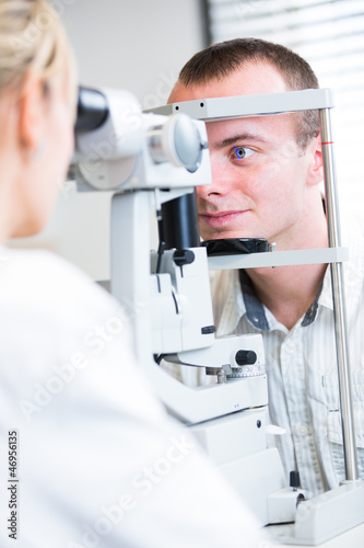 Fototapeta Naklejka Na Ścianę i Meble -  optometry concept - handsome young man having her eyes examined