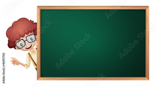 a boy and a green board