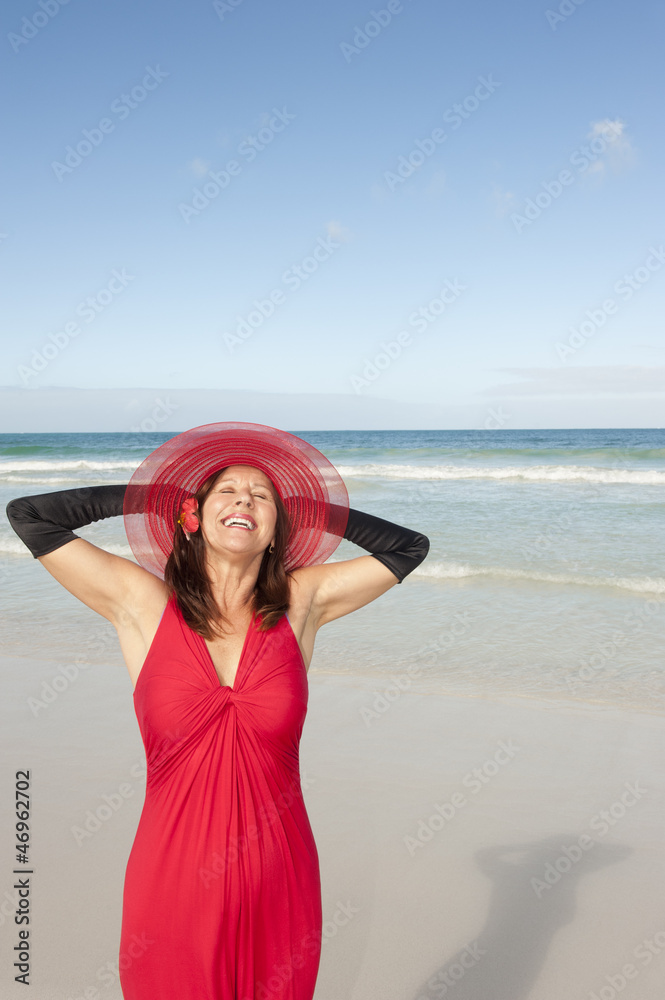 Portrait woman red dress beach