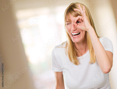 Happy Woman Looking Through Finger