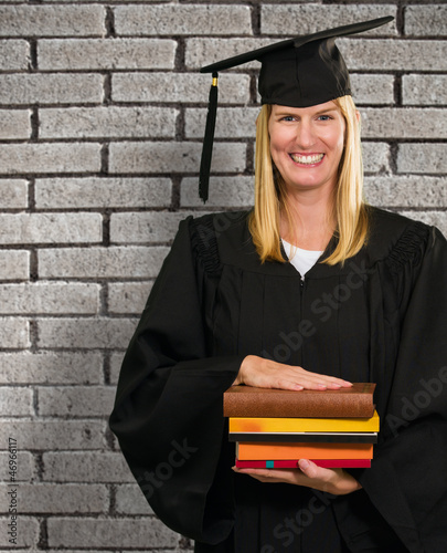 Happy Graduate Woman Holding Books photo