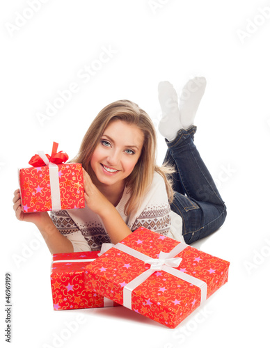 young woman holding gift, lies with three gifts is isolated on w