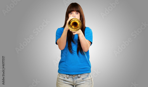 portrait of a teenager playing trumpet photo