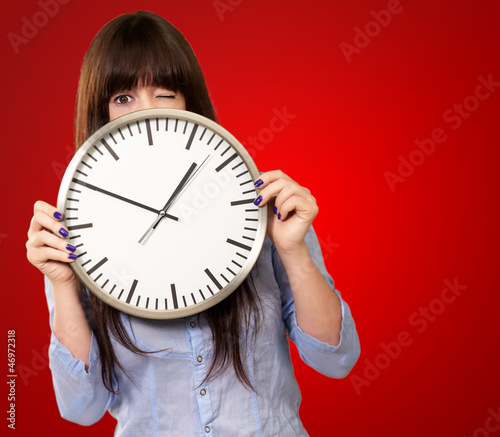 Woman Holding Clock Winking photo