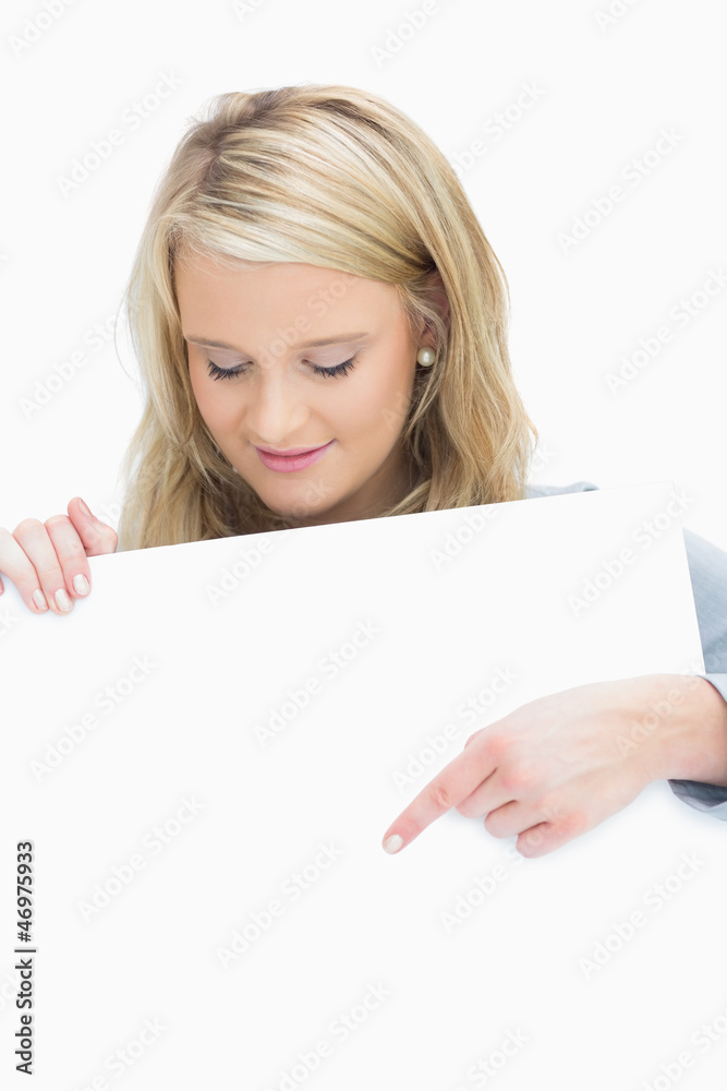 Fototapeta premium Woman looking at a poster