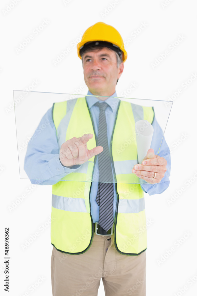 Architect using glass pane as digital tablet Architect using glass pane as digital tablet