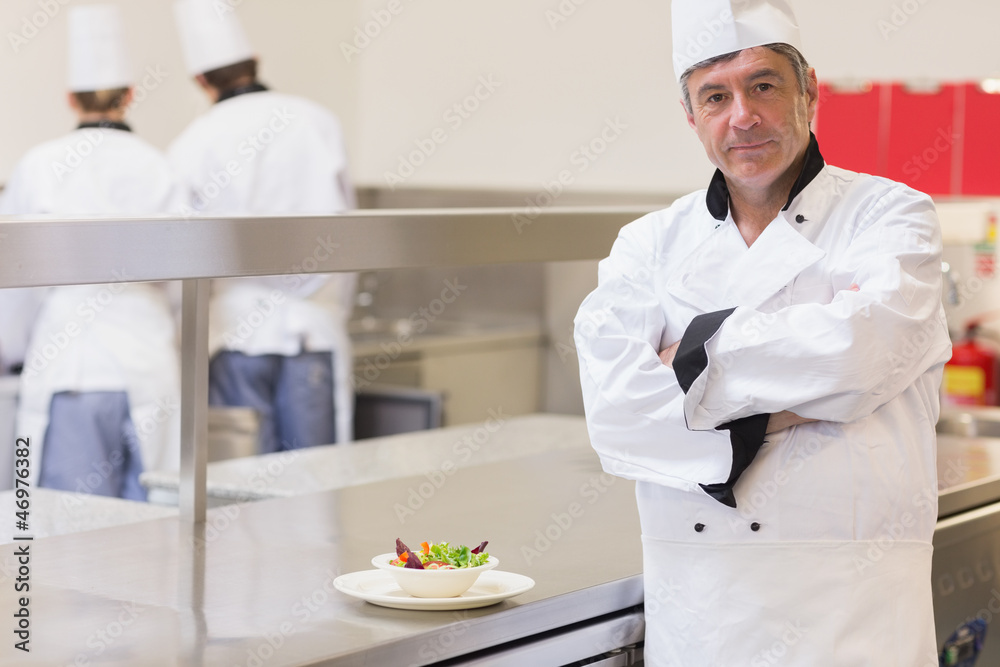 Chef standing beside salad