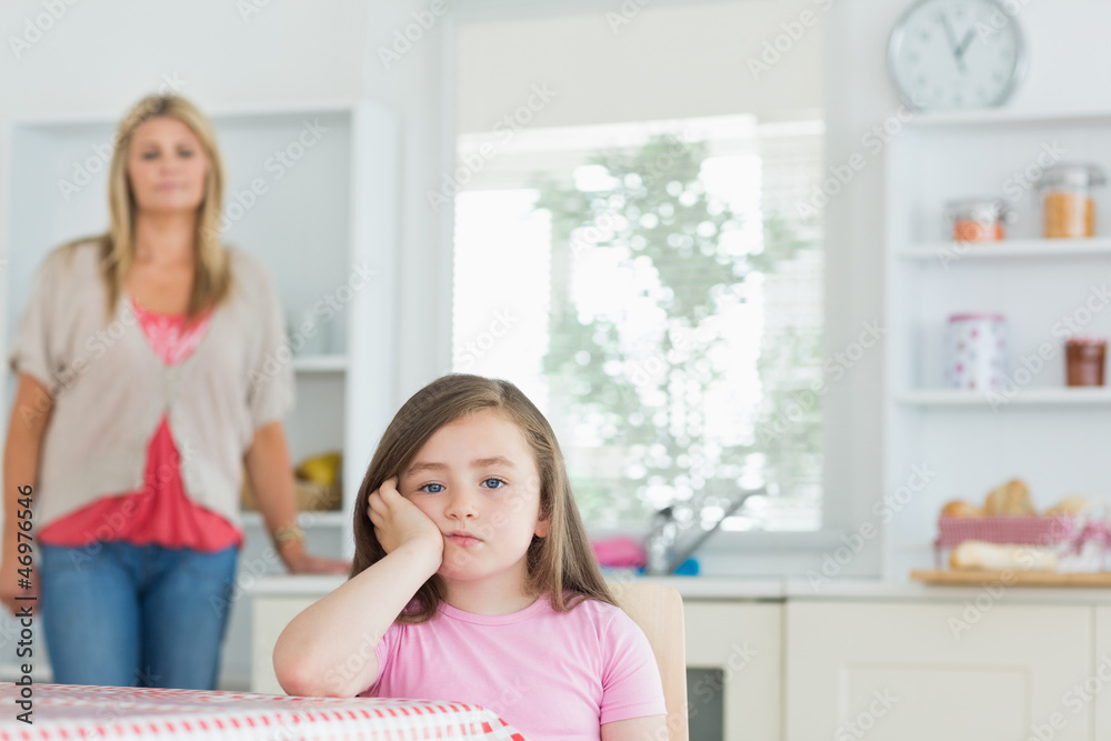 Child at kitchen table looking angry Child at kitchen table looking angry