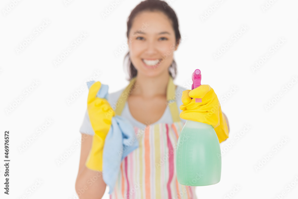 Smiling woman holding up spray bottle Smiling woman holding up spray bottle