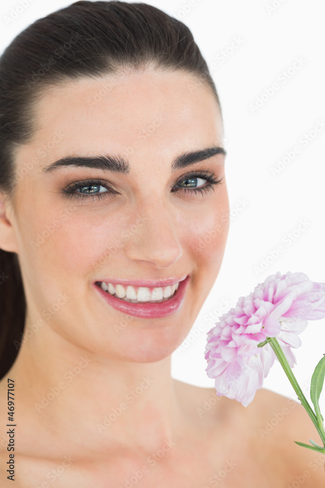 Pale woman showing a flower