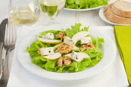 salad with gorgonzola, pear and walnut in the white plate