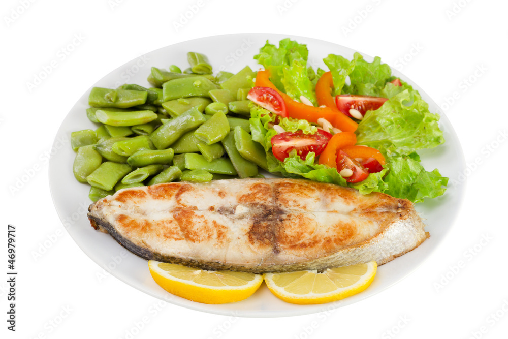 fried fish with beans and salad on the plate on white background