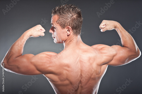 Shirtless muscled fitness man showing his back. Tough guy. © ysbrandcosijn