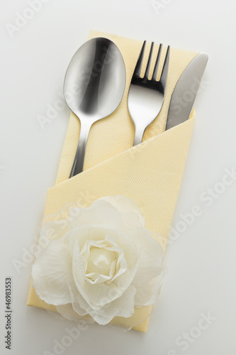 Cutlery and napkin with flower decoration