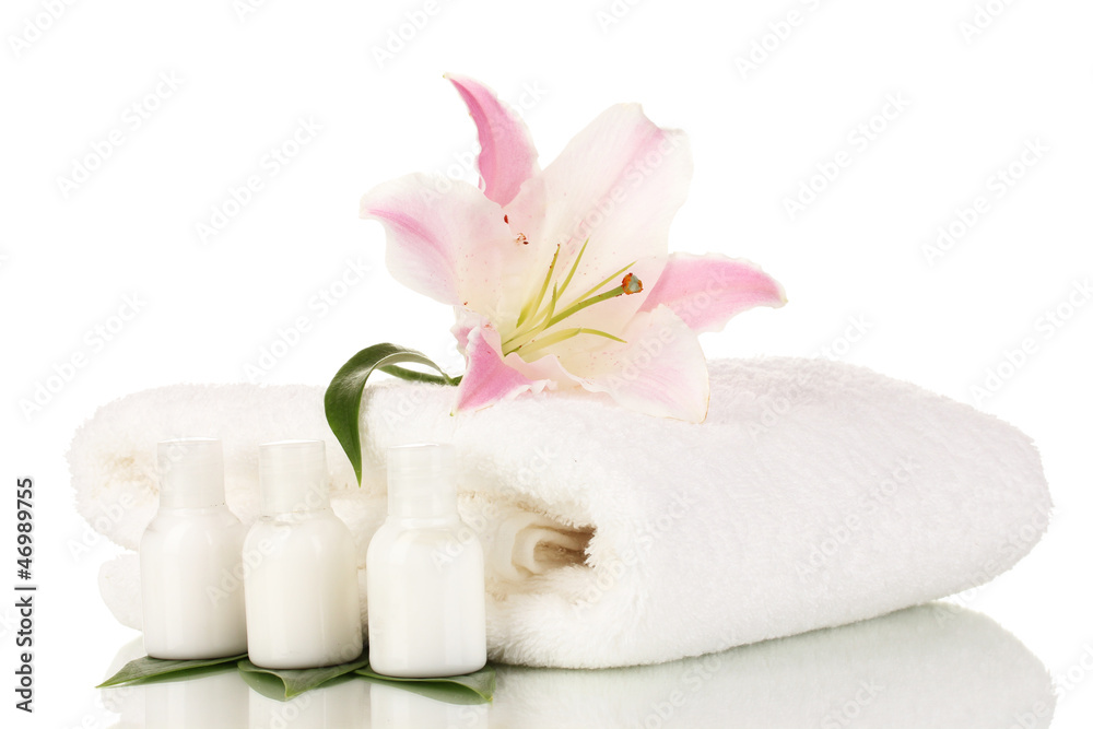 beautiful lily with towel and bottles isolated on white beautiful lily with towel and bottles isolated on white