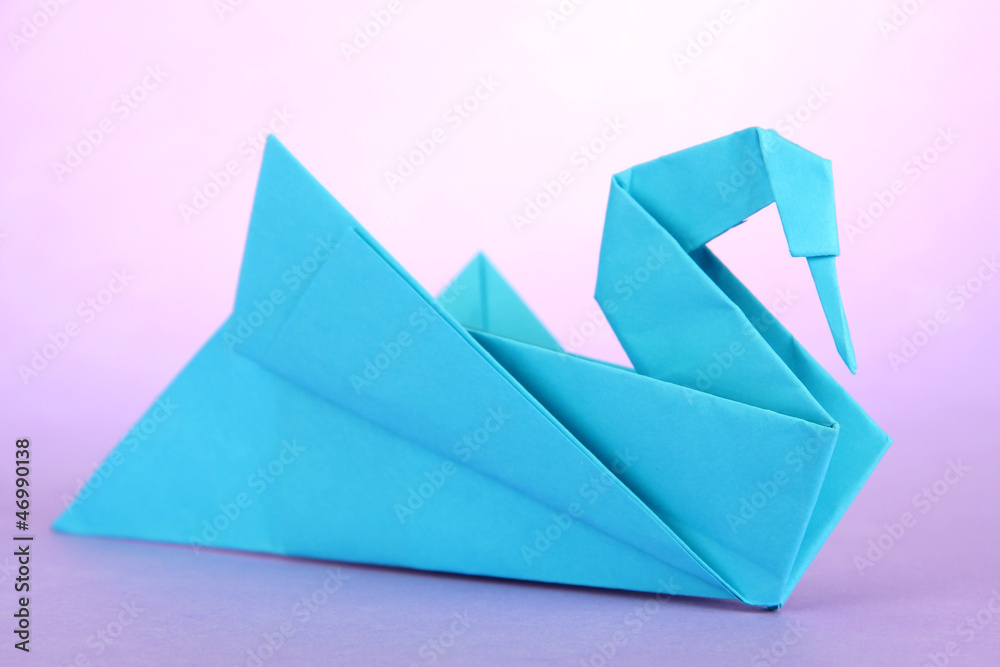 Origami swan on purple background. Origami swan on purple background.
