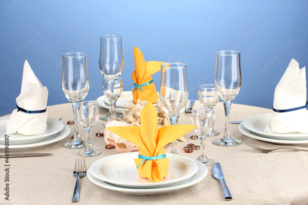 Table setting in white and yellow tones on color  background