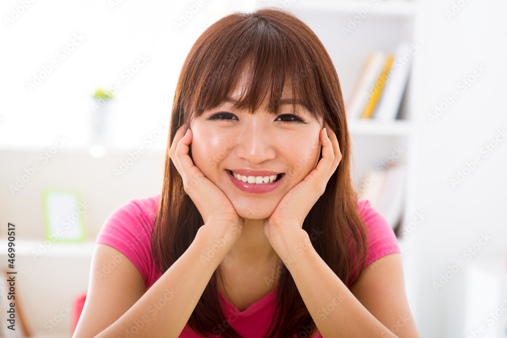 Asian girl holding her face