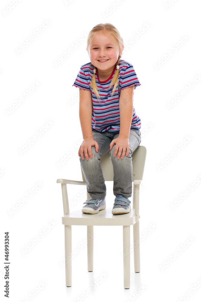 smiling girl sitting on a chair smiling girl sitting on a chair