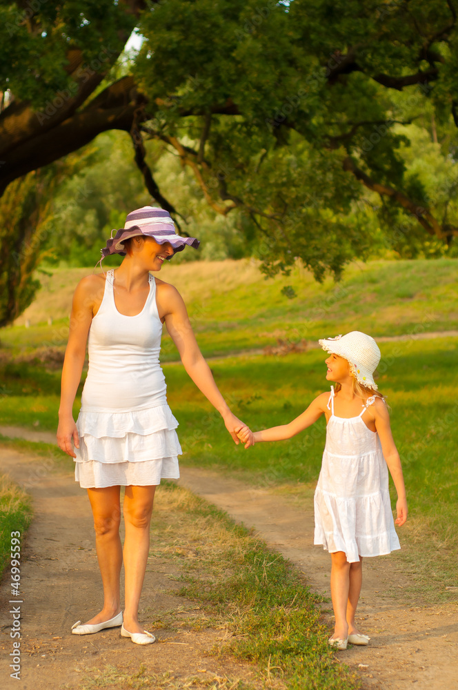 Mother and daughter walking in the nature