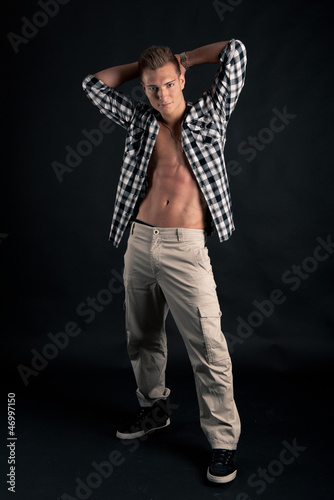 Studio portrait of confident young man with plaid shirt 