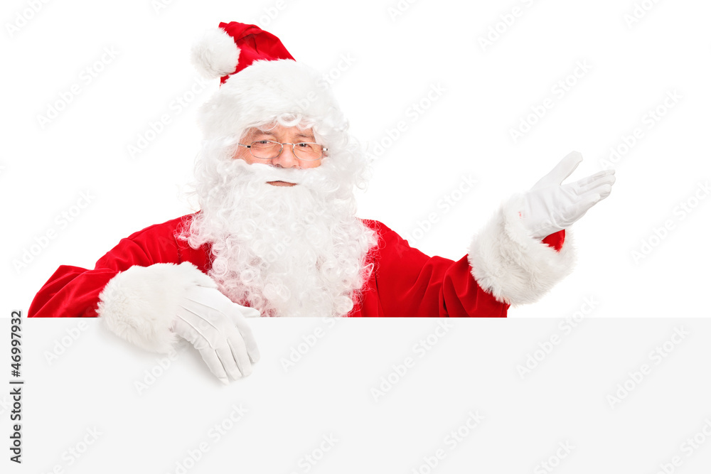 Santa Claus posing behind a billboard and gesturing Santa Claus posing behind a billboard and gesturing