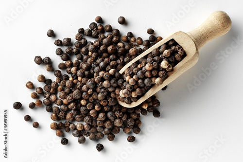 black peppercorns with wooden spoon