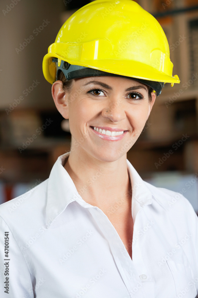 Female Supervisor Wearing Hardhat At Warehouse Female Supervisor Wearing Hardhat At Warehouse
