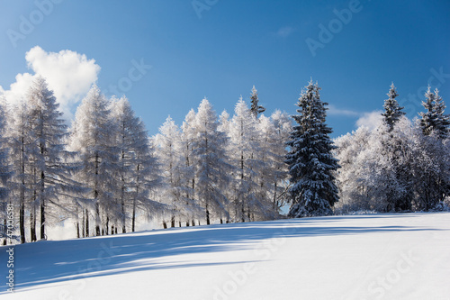 Snowy mountain scenery with deep blue sky © lightpoet