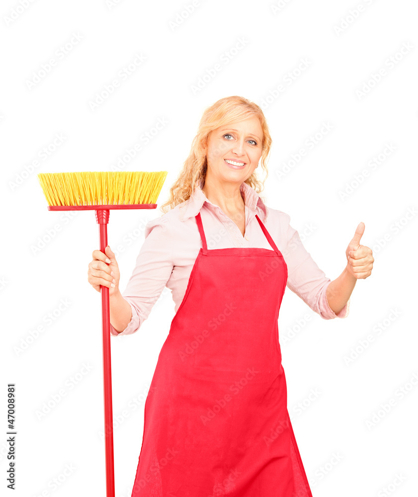 Female cleaner posing with brush and giving thumb up Female cleaner posing with brush and giving thumb up