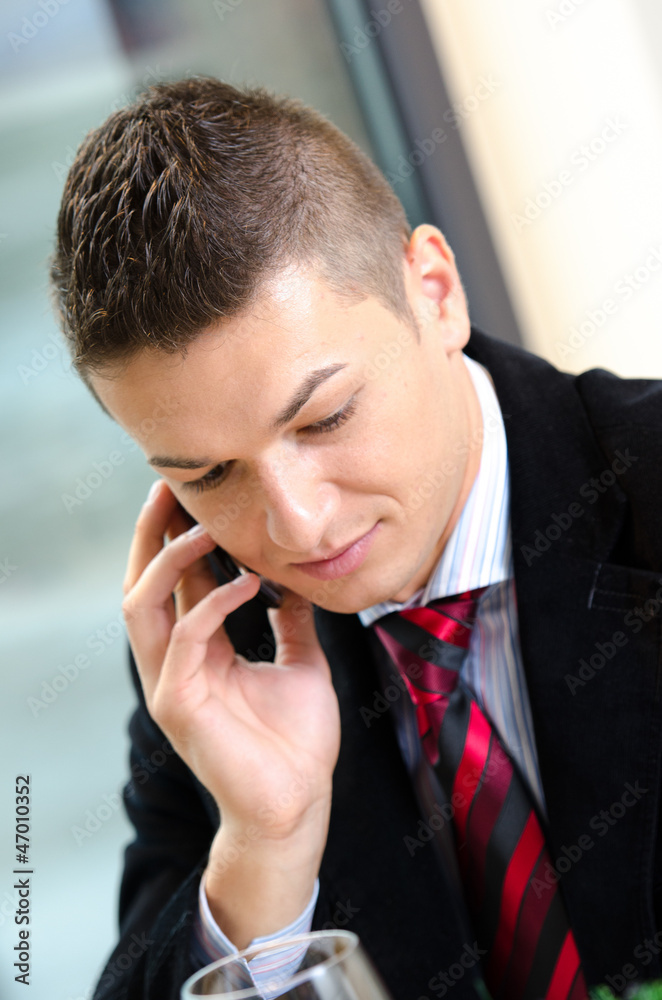 Young business man talking on the phone during lunch time Young business man talking on the phone during lunch time