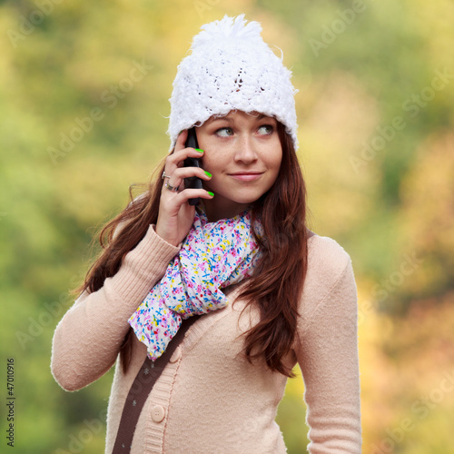 Cute Smiling Girl listening to mobile phone