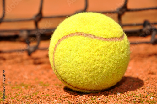 Tennis ball on a tennis clay court