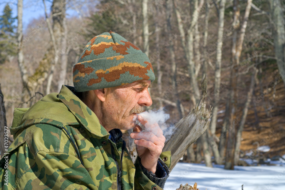Man smoking in forest 3