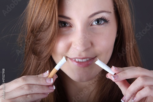 woman and stop smoking cigarette (focus on cigarette)