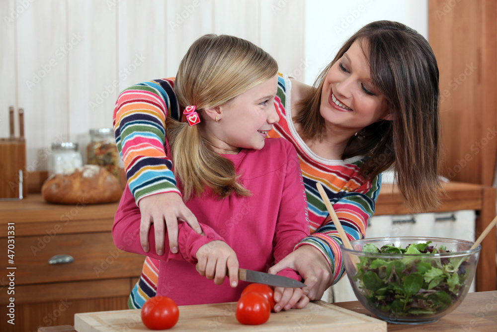 Fototapeta premium Mother cooking with daughter