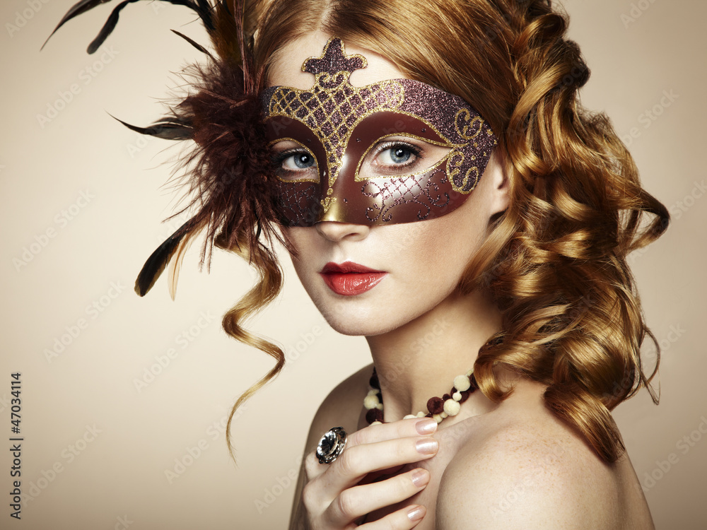 Beautiful young woman in brown mysterious venetian mask