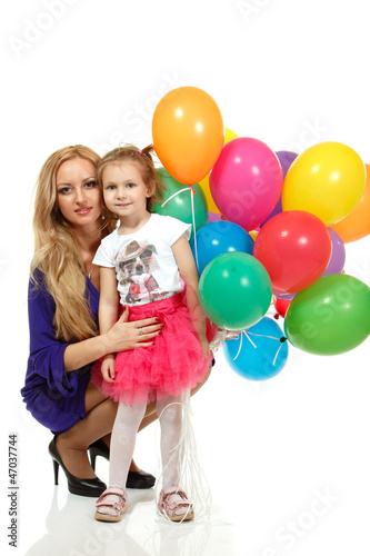 Mother with liitle daughter with multicolor balloons